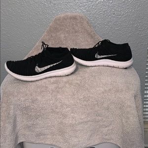 Black and white nike flyknit sneakers